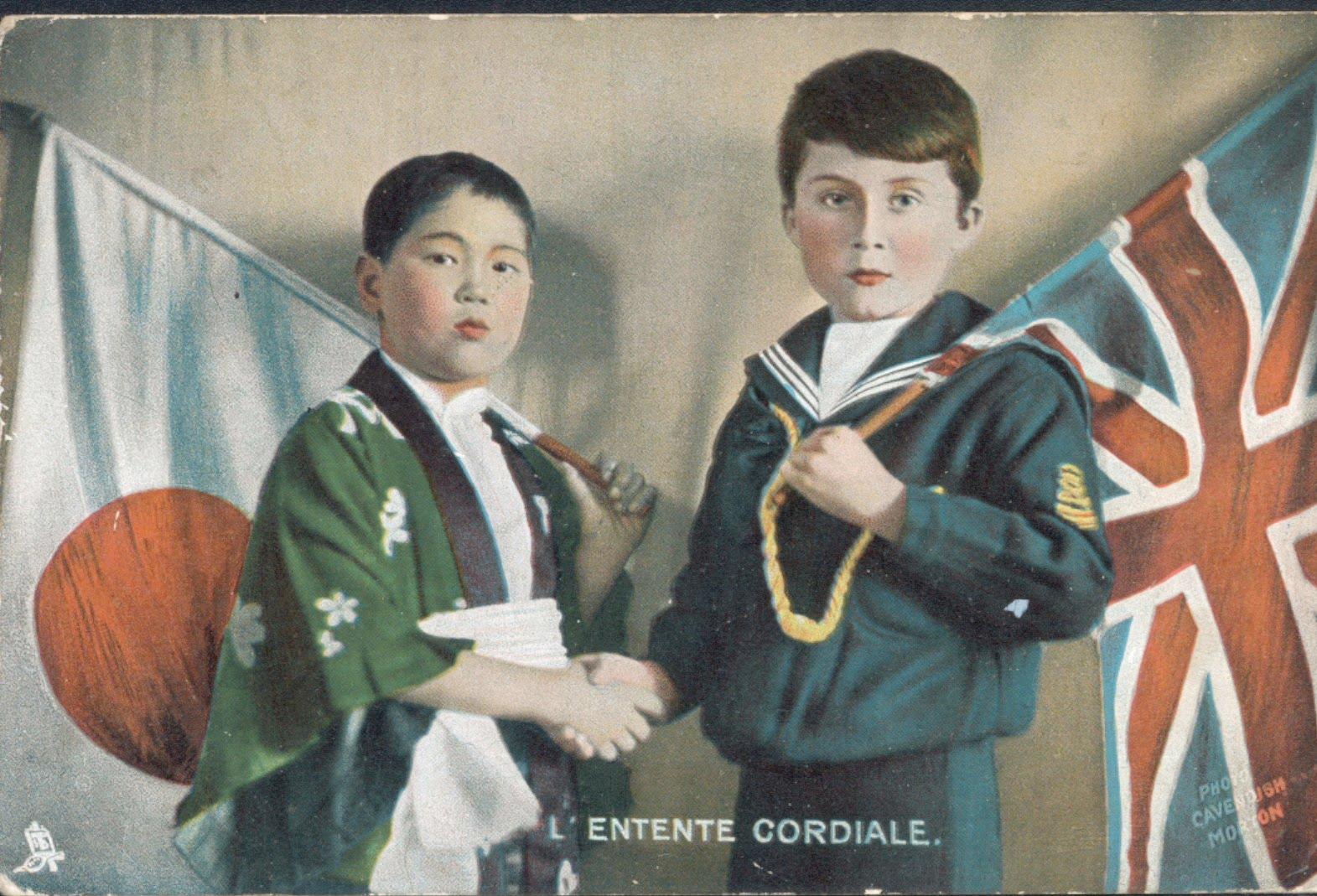 Two children dressed in traditional attire and naval uniform, shaking hands, with Japanese and British flags in the background.
