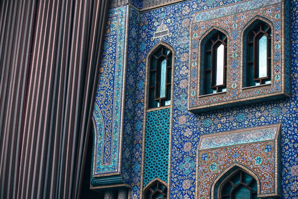 Expressive blue tiles and arched windows show traditional Arabic styling.