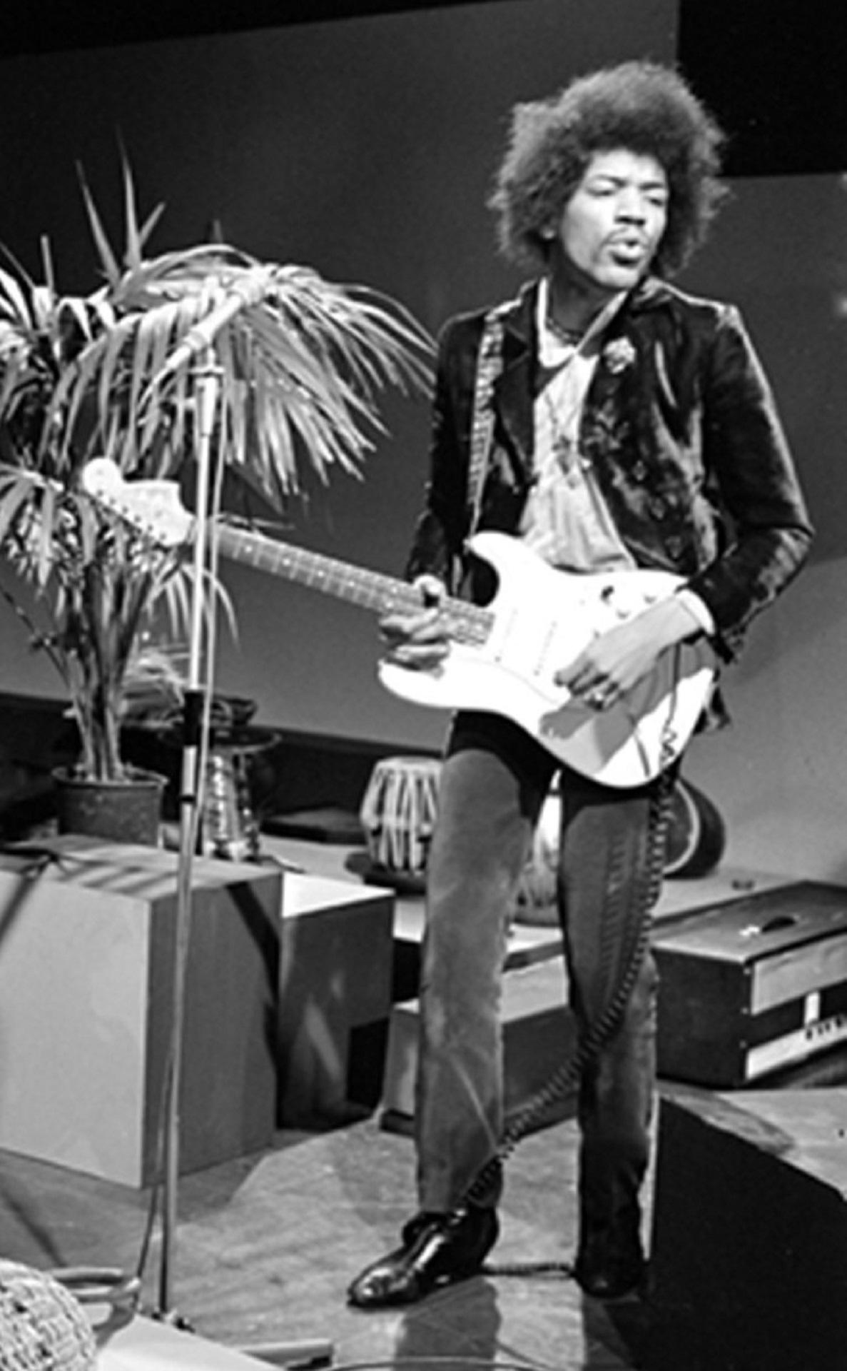 A black and white photo of a man playing guitar