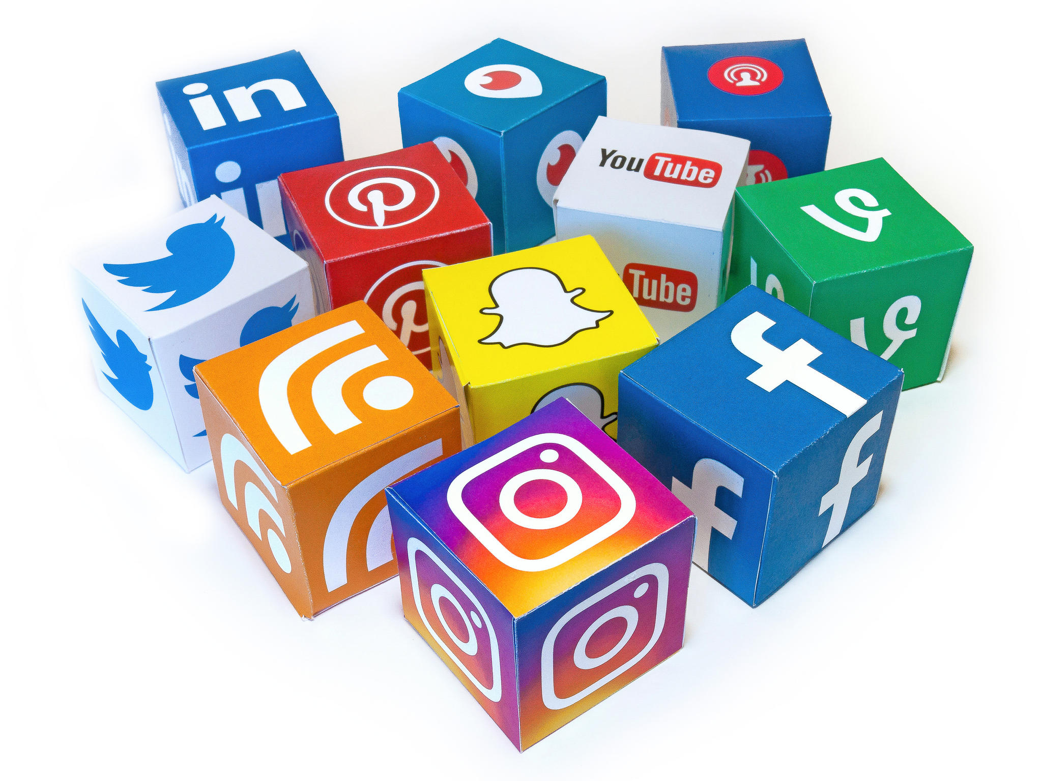 A collection of blocks with social media logos on them. Social media is a great way to keep up to date with economics news.