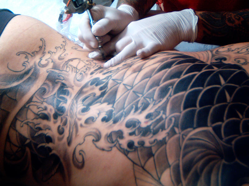 A Japanese tattoo being drawn on