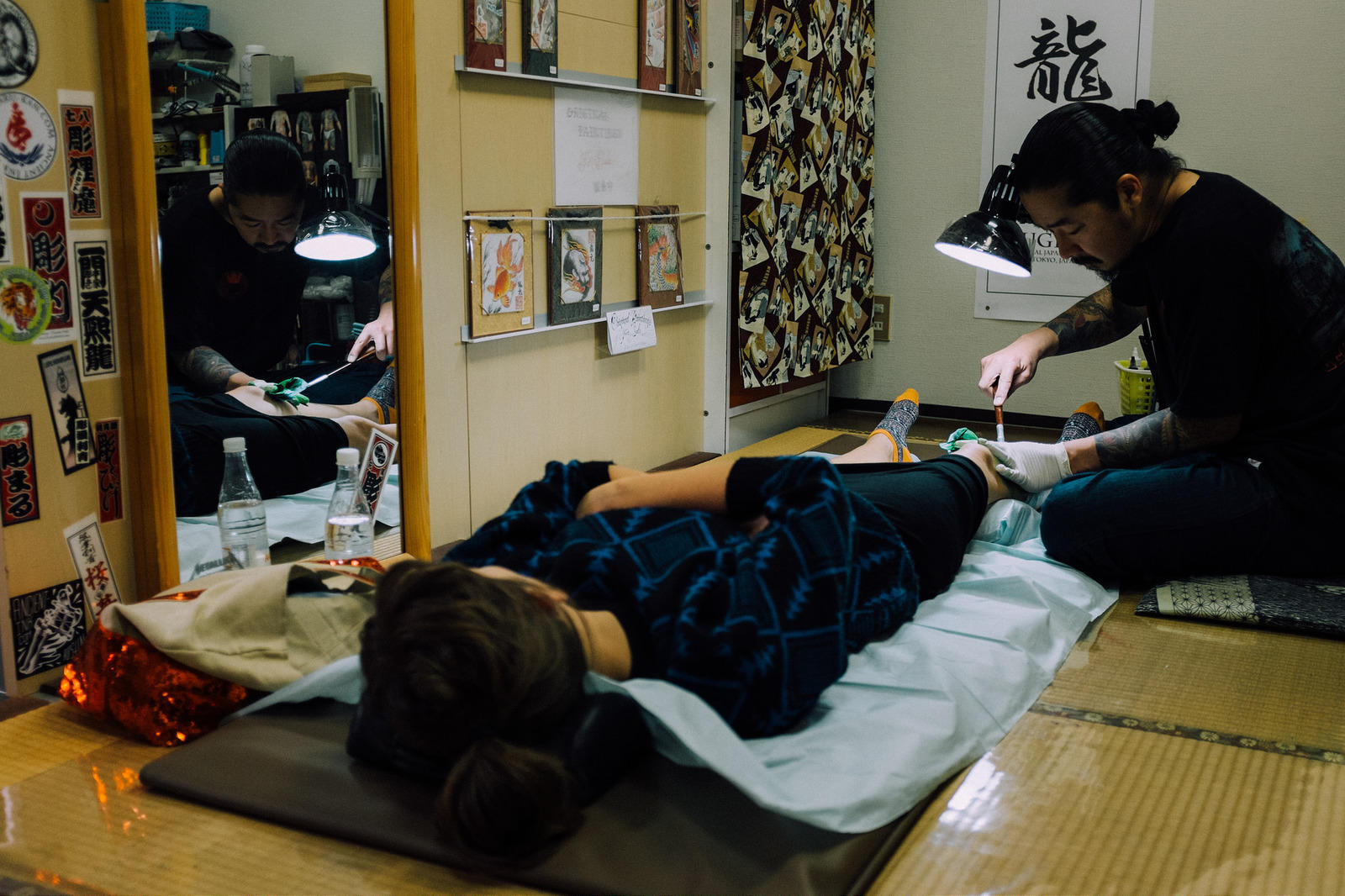 A lady getting a Japanese tattoo