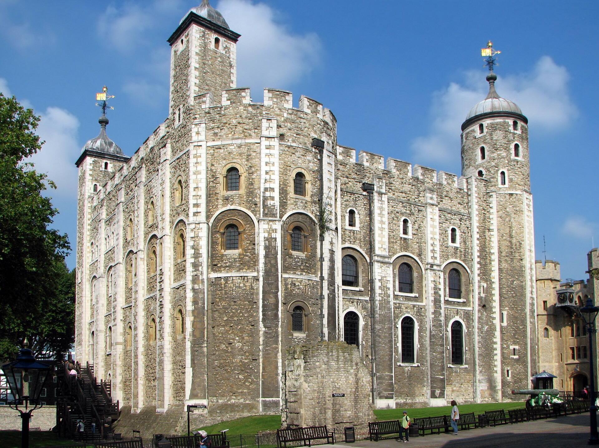 A large, square stone building on a sunny day. 
