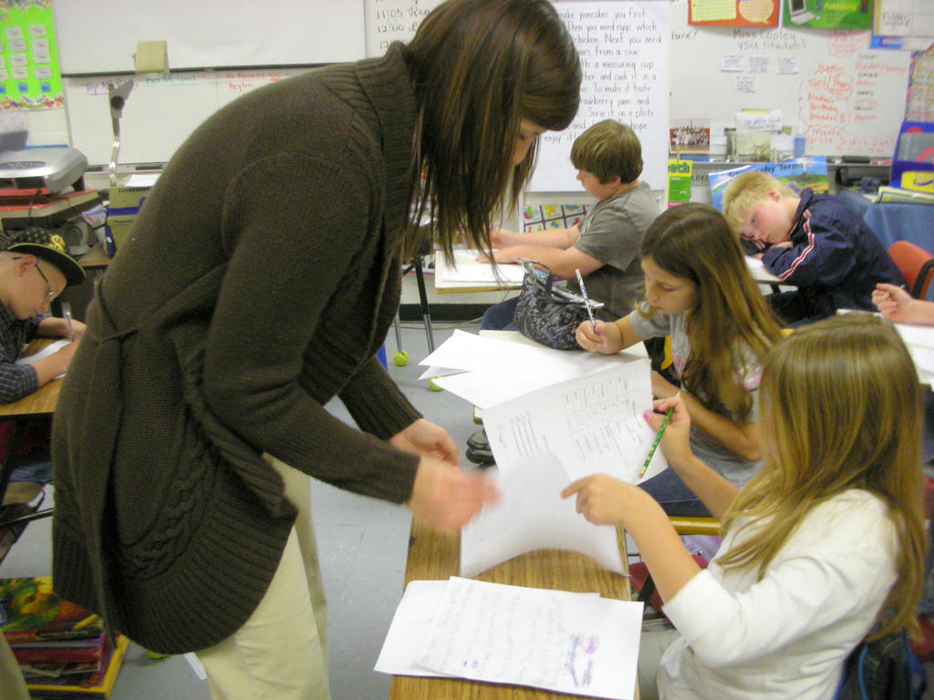 Teacher helping a student in class.