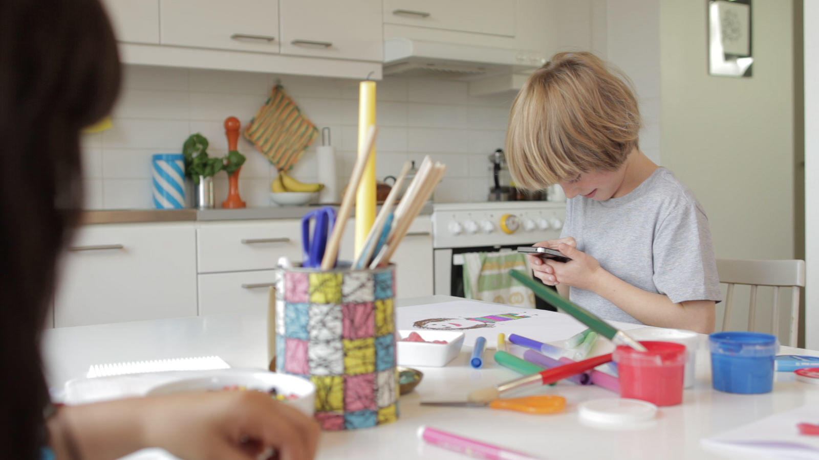A child using smartphone to draw.