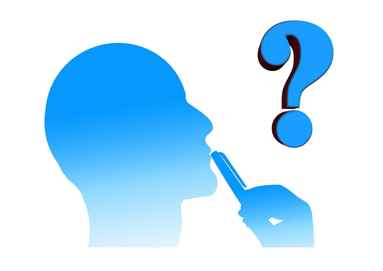 A man holding a pen to his mouth with a question mark above his head. Many people have asked the question: what is economics?