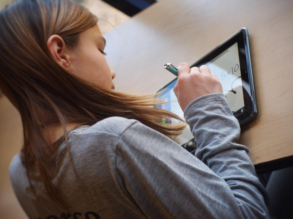 Student using a tablet for her revision.