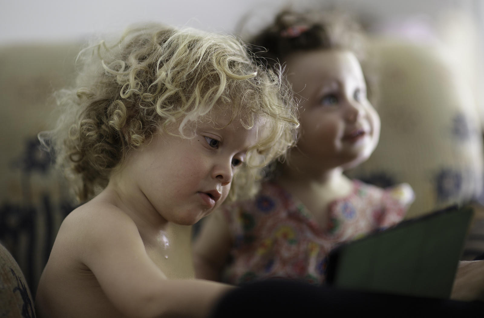 Very young child using a tablet.
