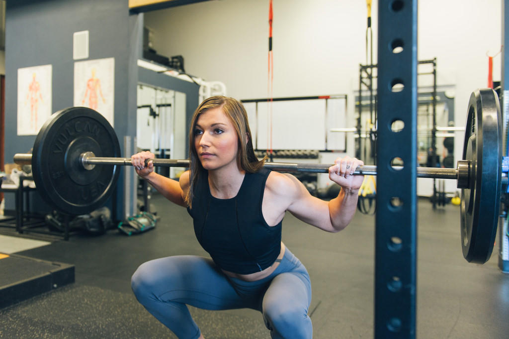 Squat with good form to prevent back injury.