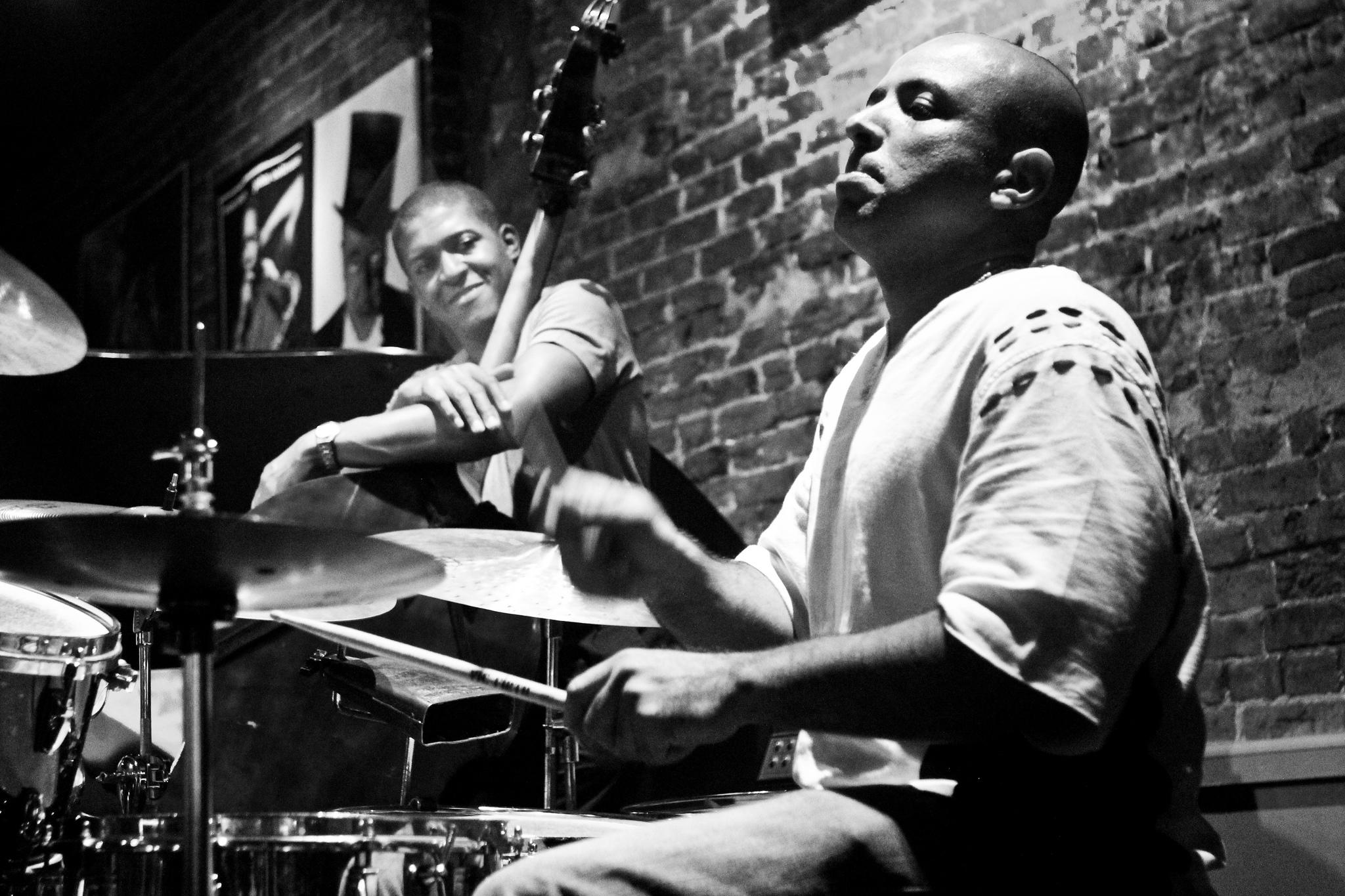 Drummer and bassist playing together.