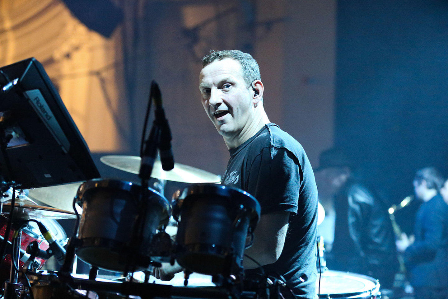 Darrin Mooney performing with Primal Scream.
