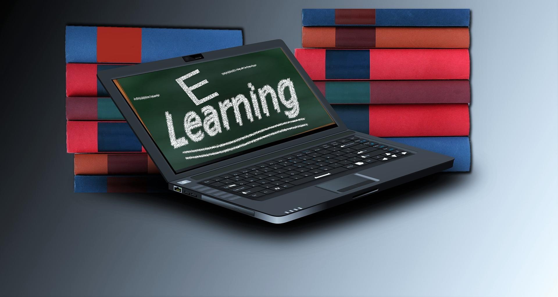 A laptop with "e-learning" written on the screen with images of books behind it. You can learn Hindi online.