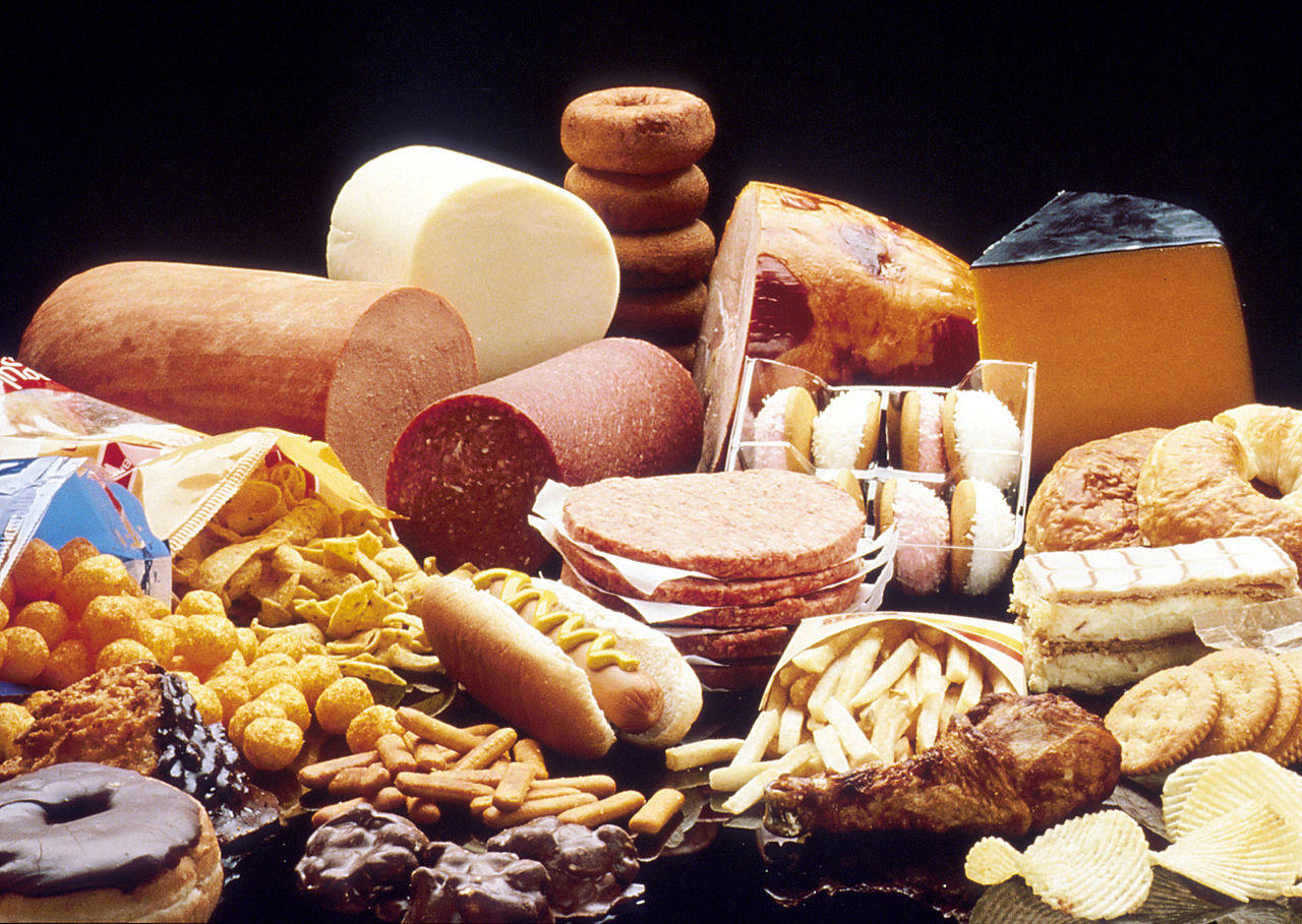 A collection of high fat foods. Looking at food labels can help avoid eating as many high fat foods.