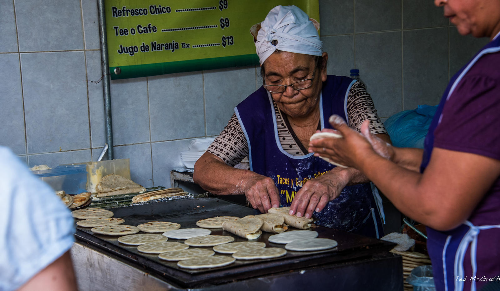 A chef making tacos by hand.