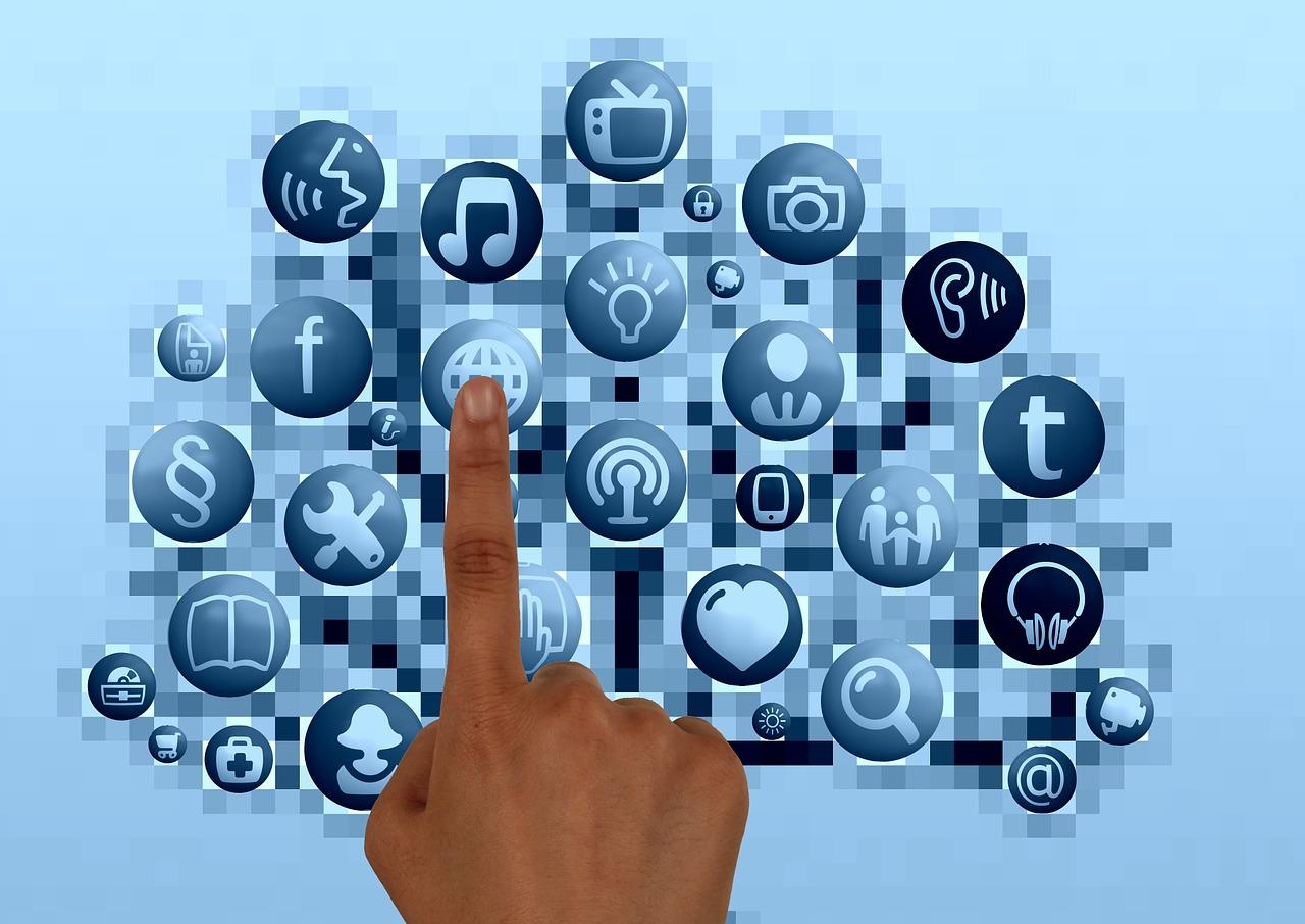 A finger hovering over the images of lots of different apps. Using a language app can be a good way to learn Dutch online.