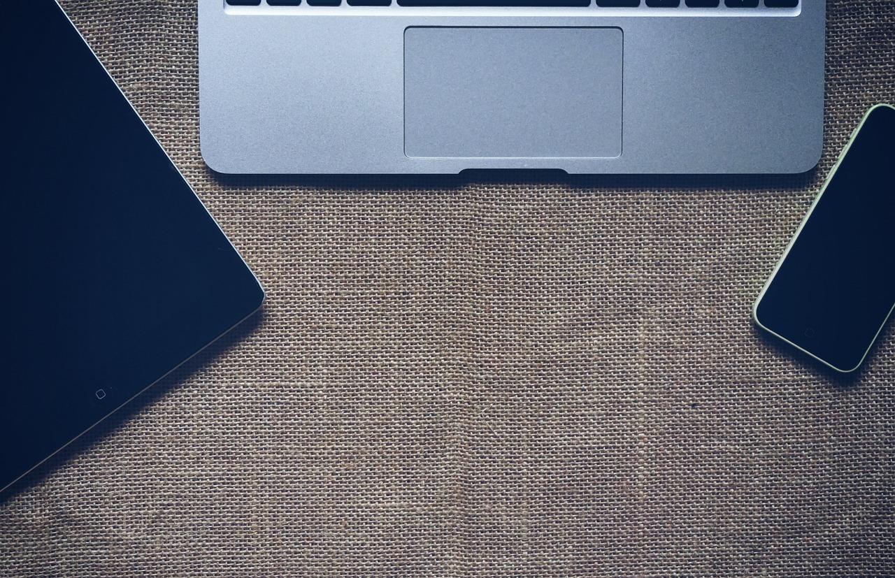 From left to right: An iPad, laptop, and iPhone placed on top of a sackcloth. There are lots of apps available that you can use to learn Dutch.
