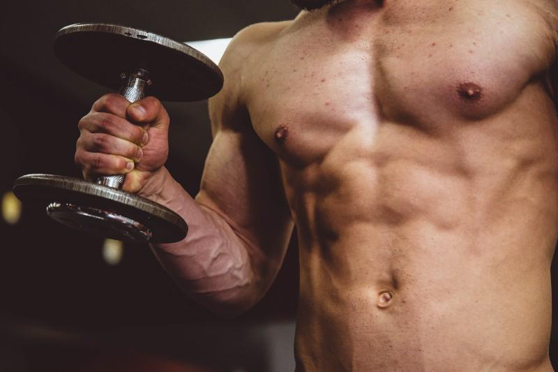 Muscular chest lifting dumbbell