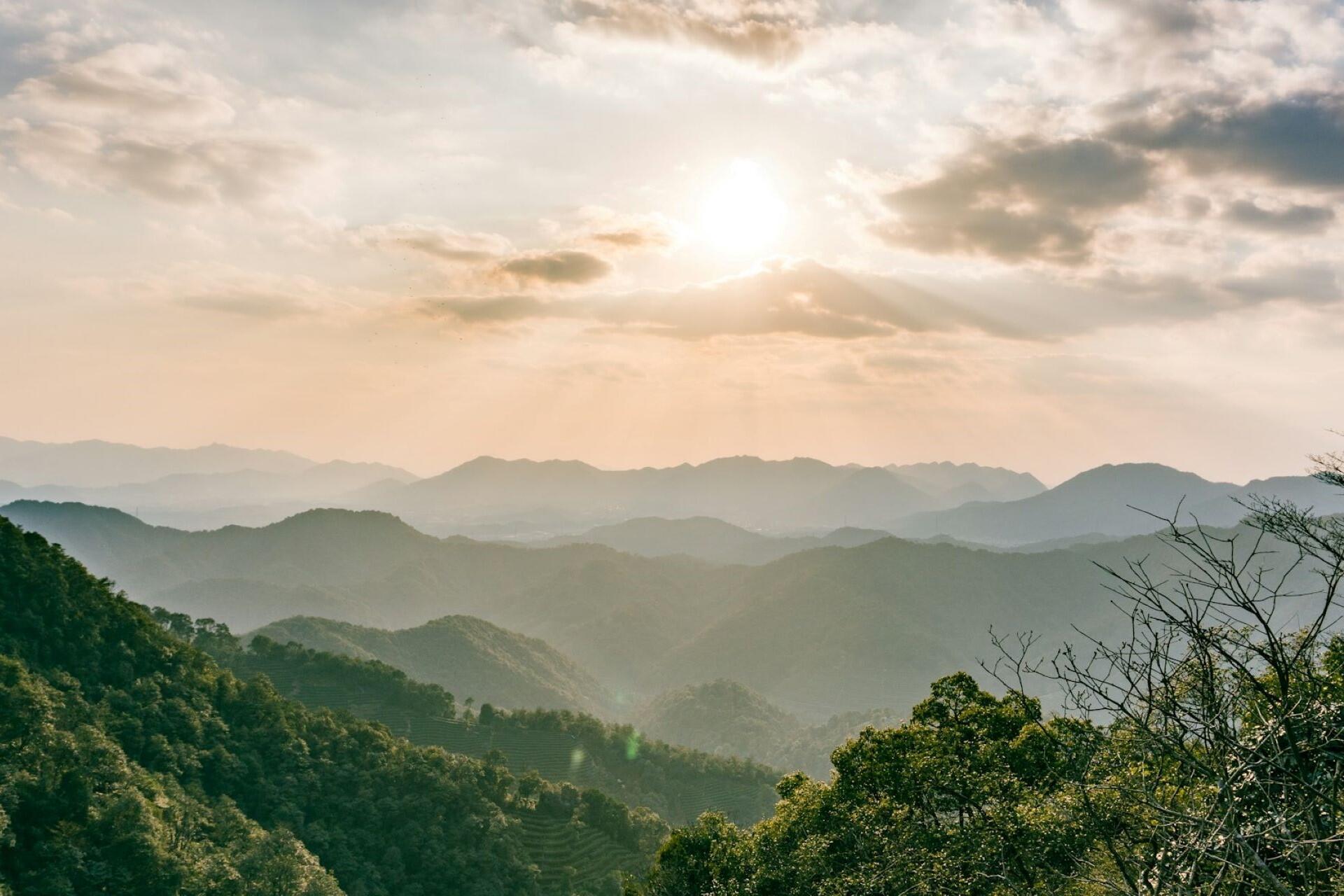 Sunshine breaking through the clouds overlooking a mountain