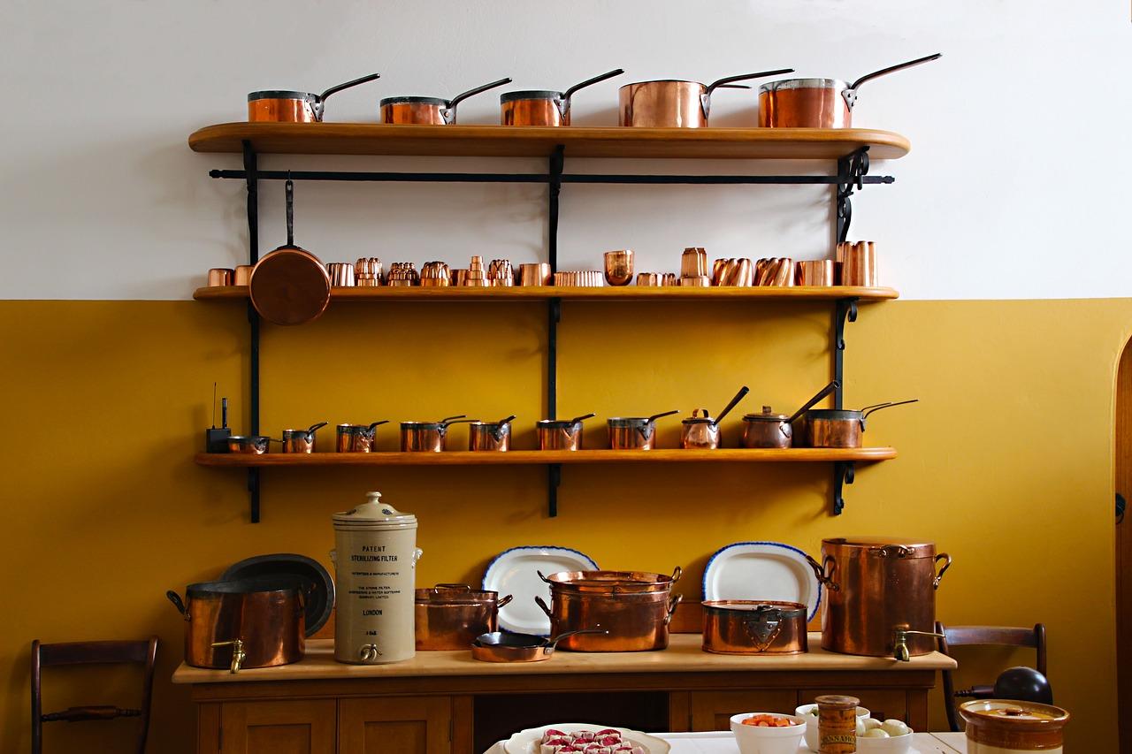 Shelves of copper pots and pans. You can repurpose household items like pots and pans to learn how to drum.