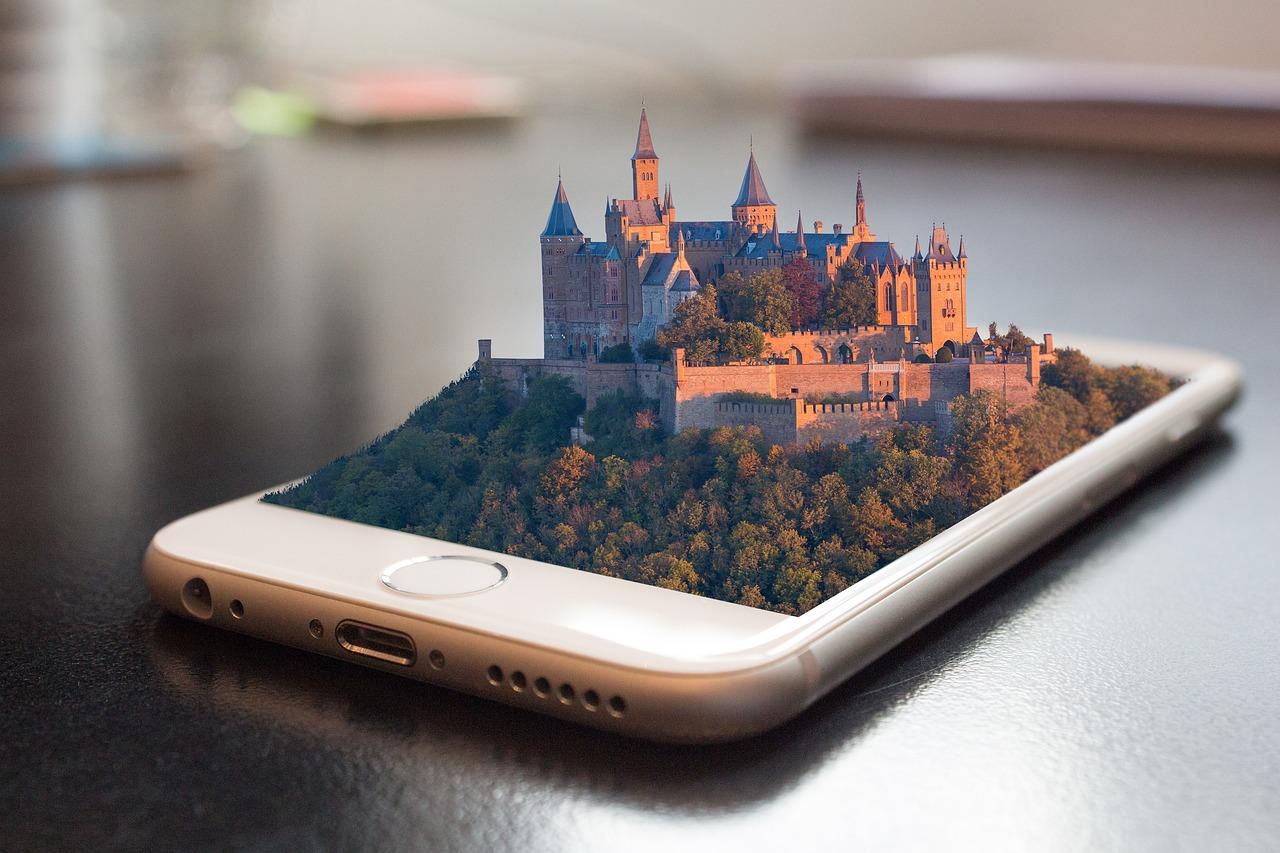 A castle emerges from a mobile phone.