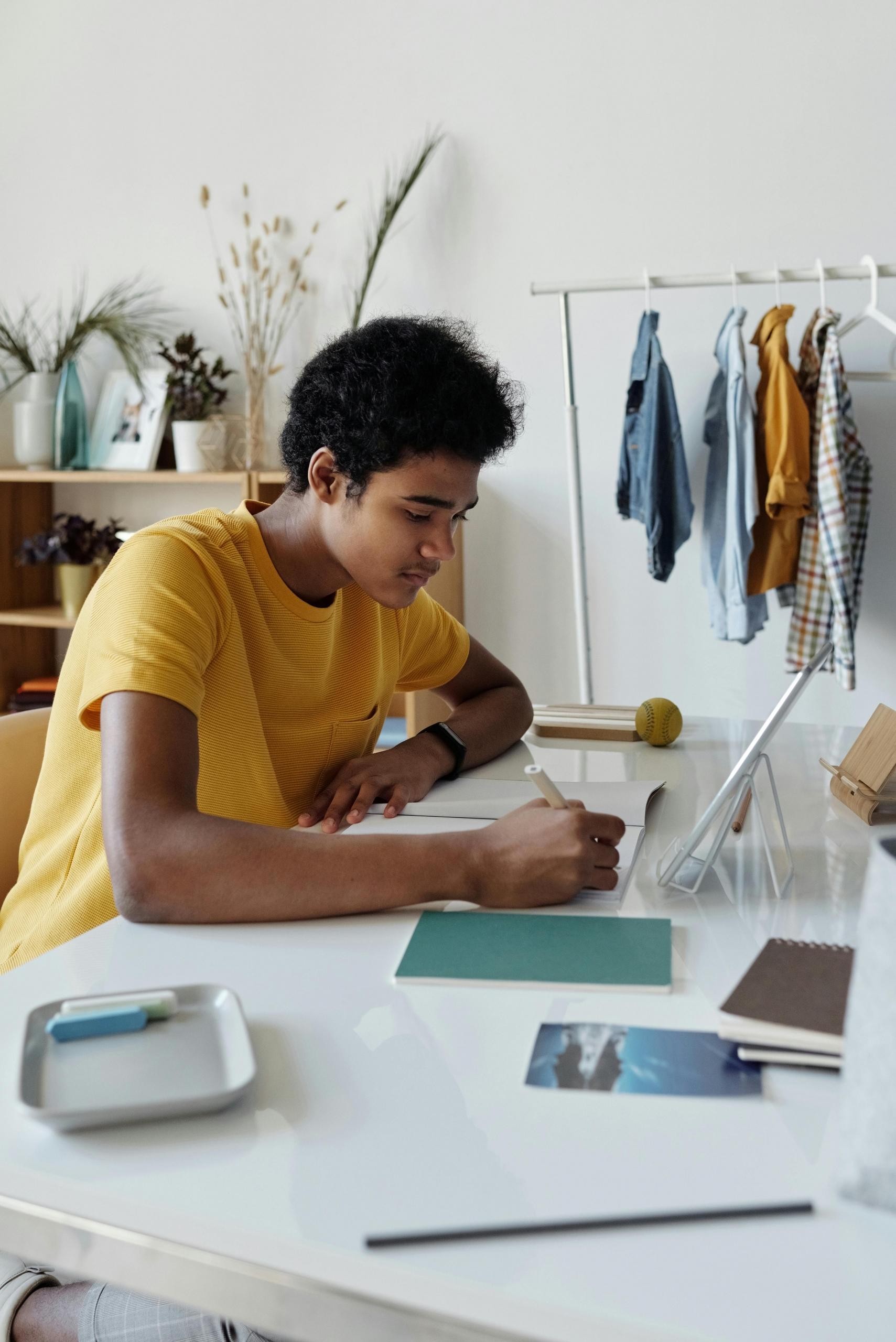 A student sitting at his desk at home learning history before an upcoming exam