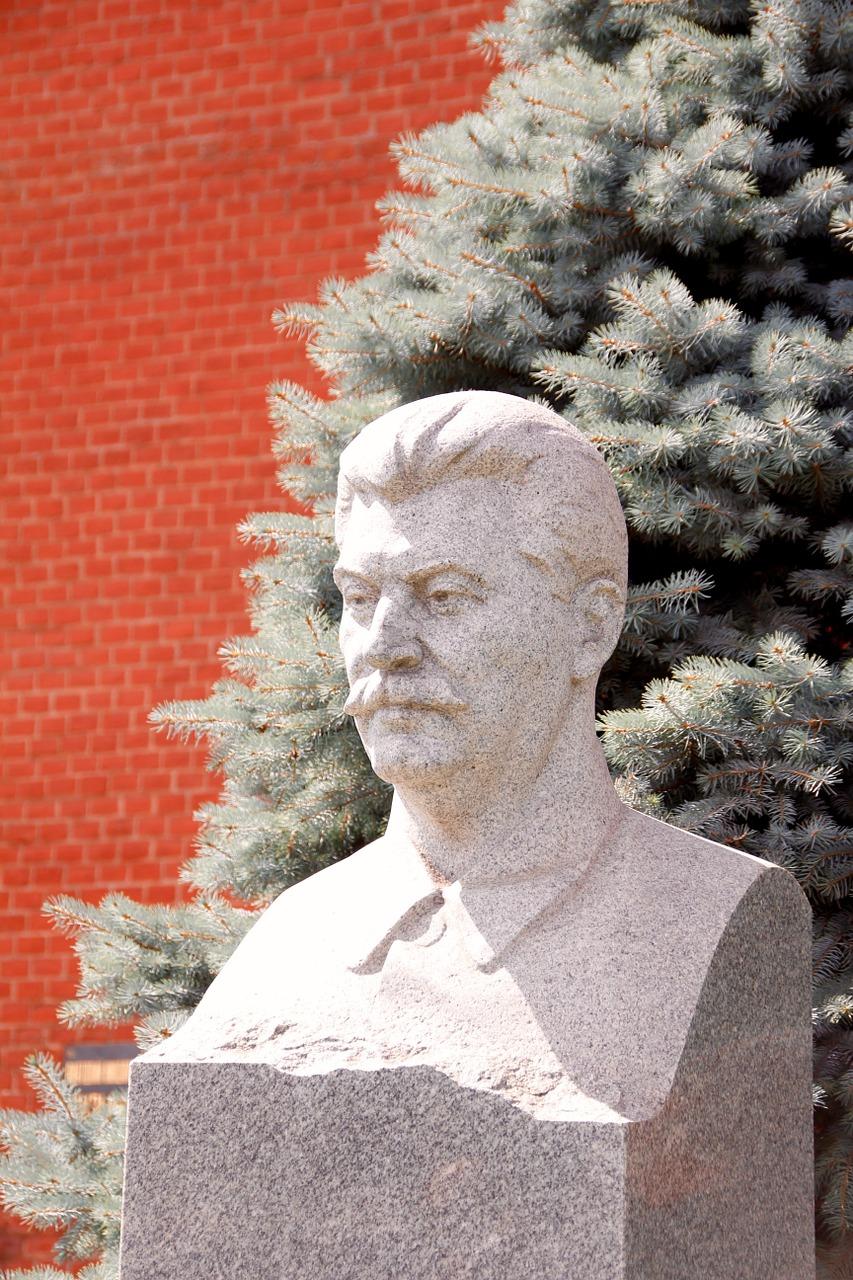 Bust of Stalin against red background.