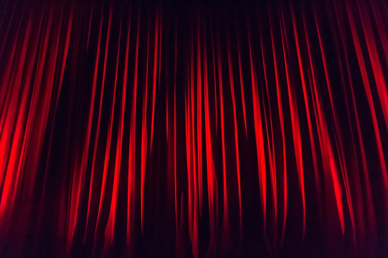 Red theatre curtains. You might practice acting on stage as part of an acting class.