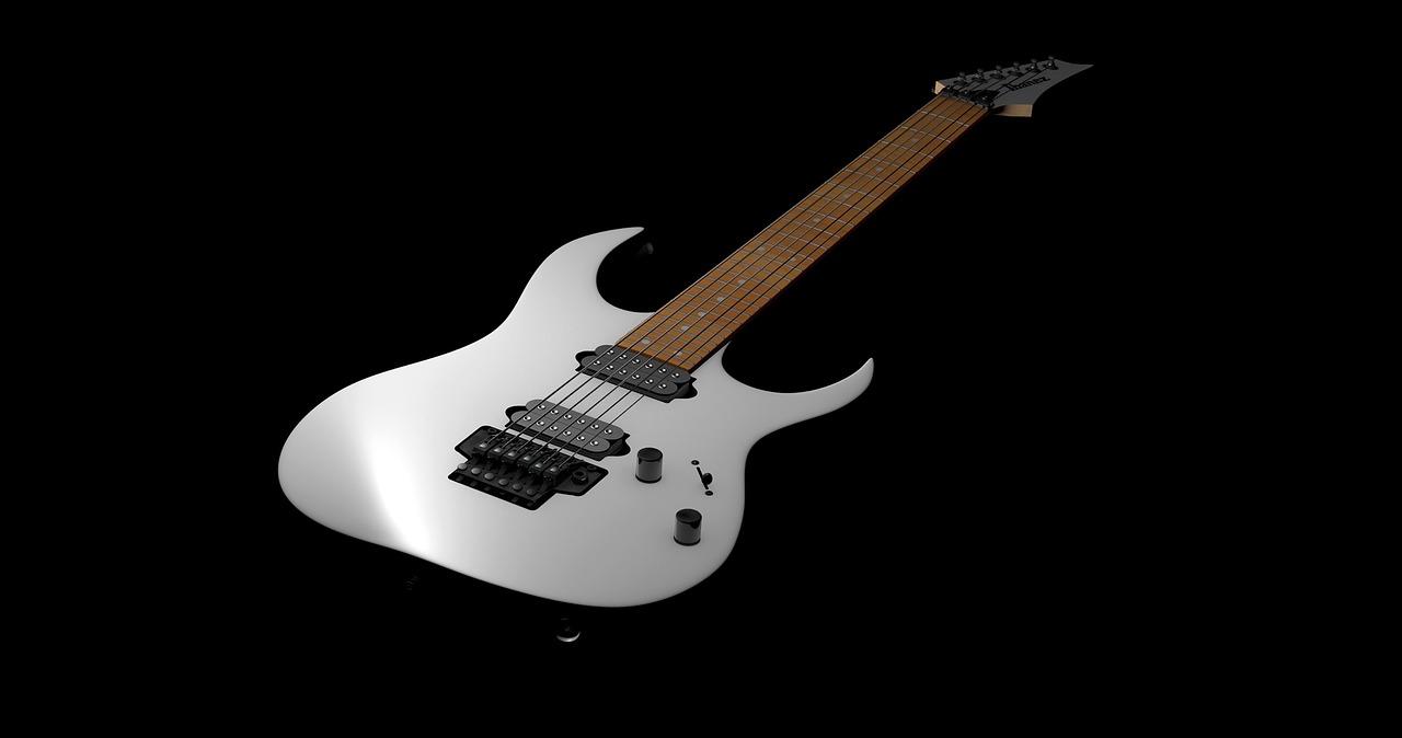 Electric guitar against black background.