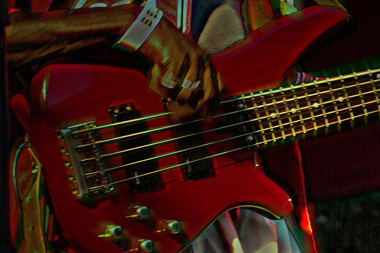 Someone playing the bass guitar