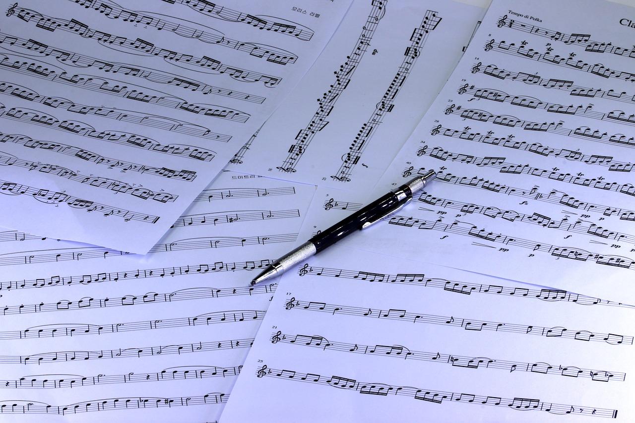 Scattered sheet music with pen