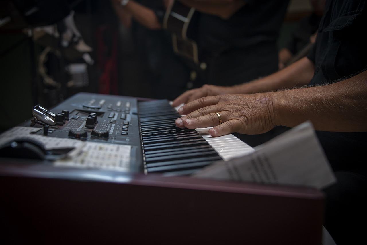 Piano keyboard with hands.