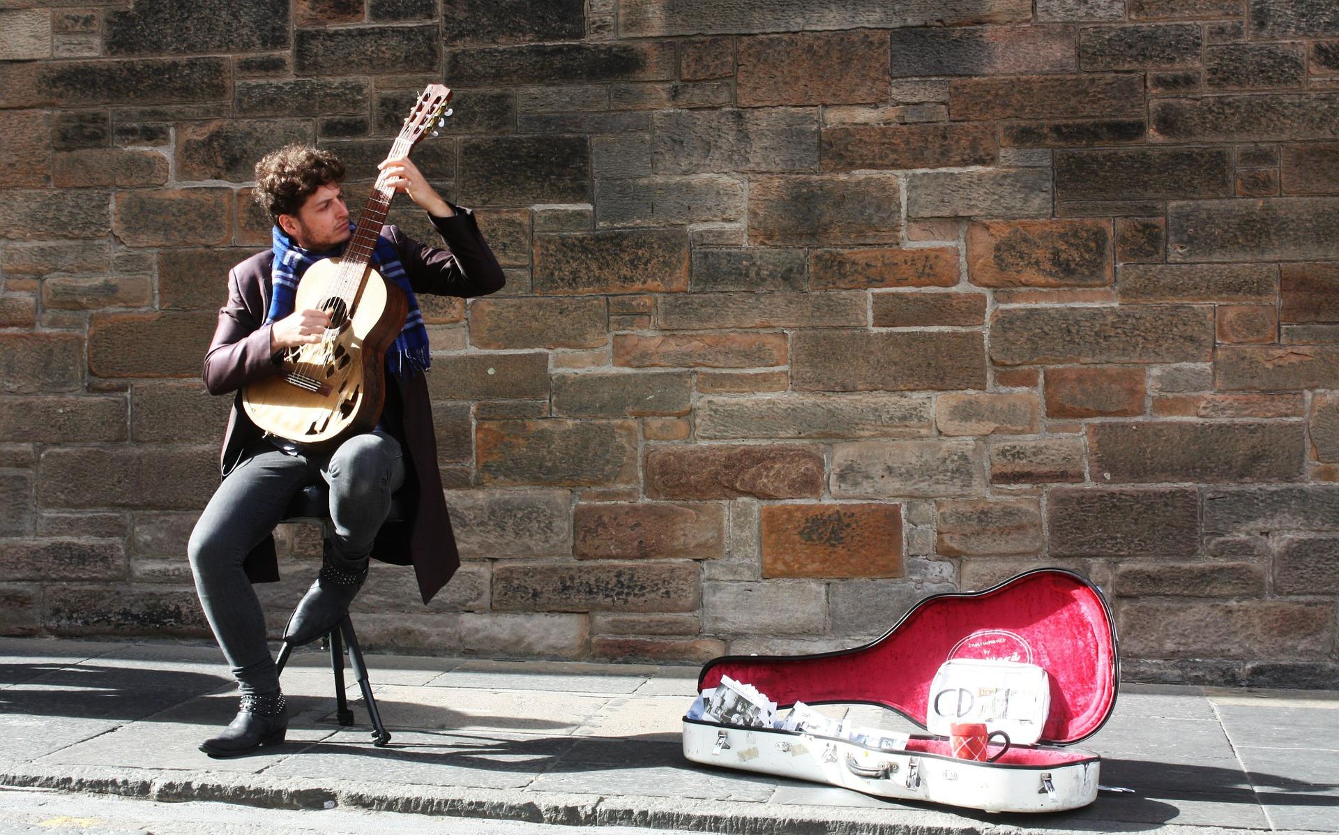 A street musician playing a guitar