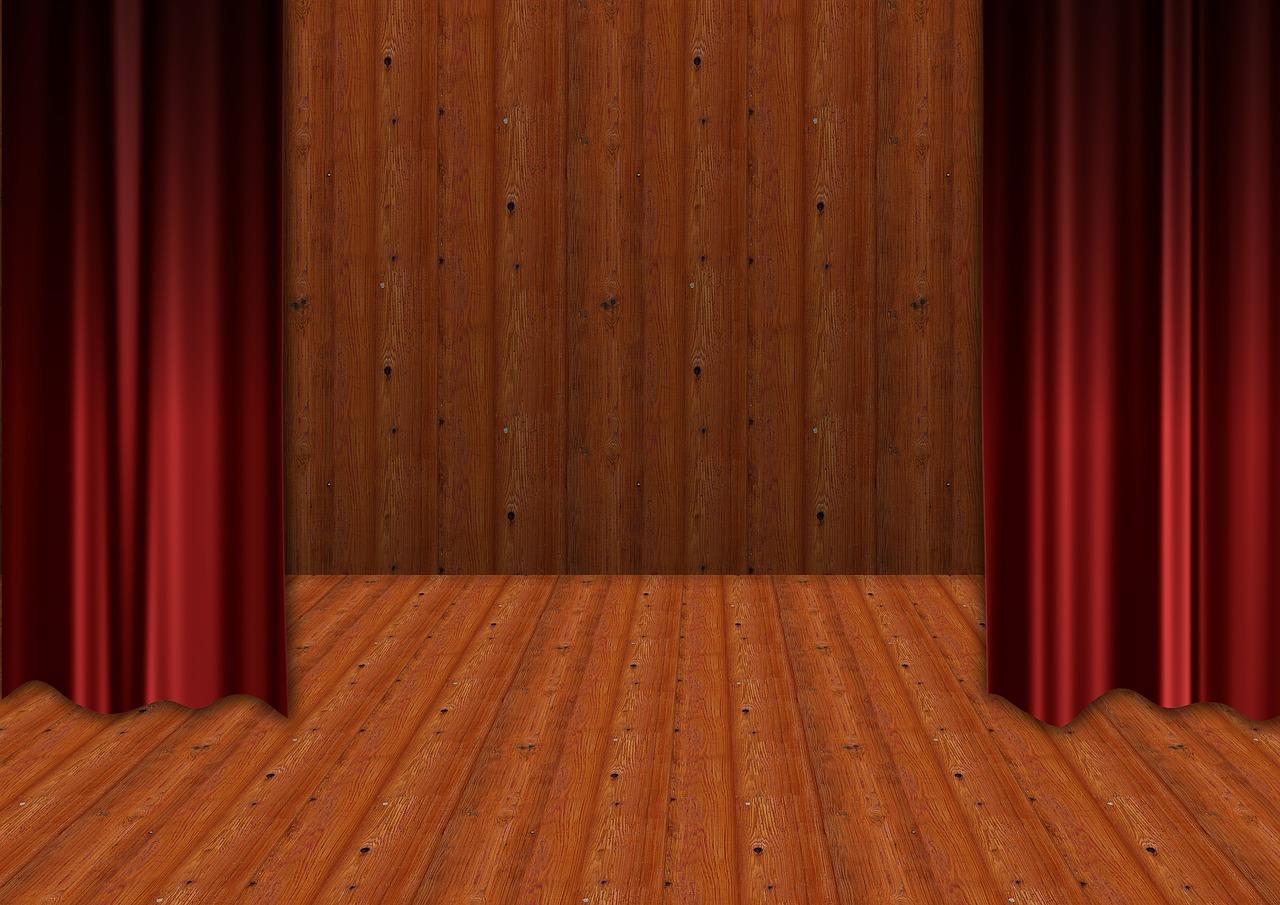 A theatre stage with the curtains drawn open