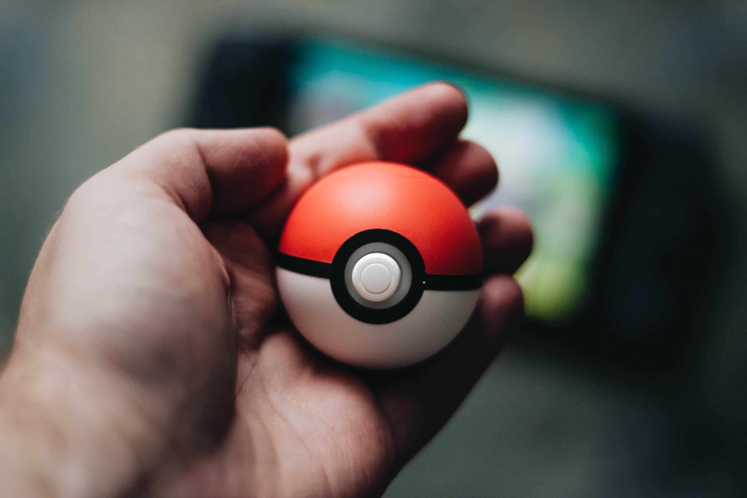 Someone holds a Pokemon toy