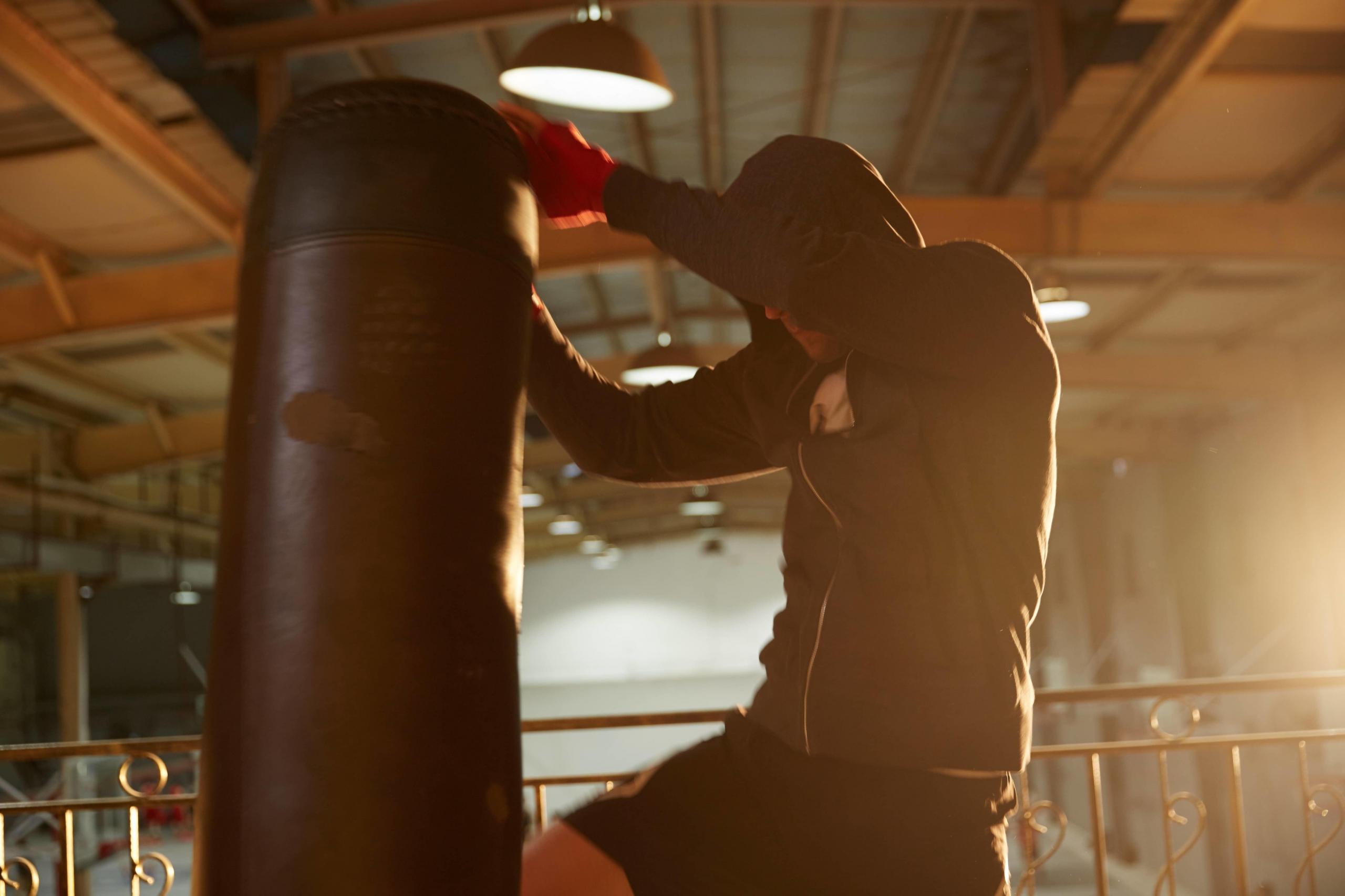 man kicks a punch bag