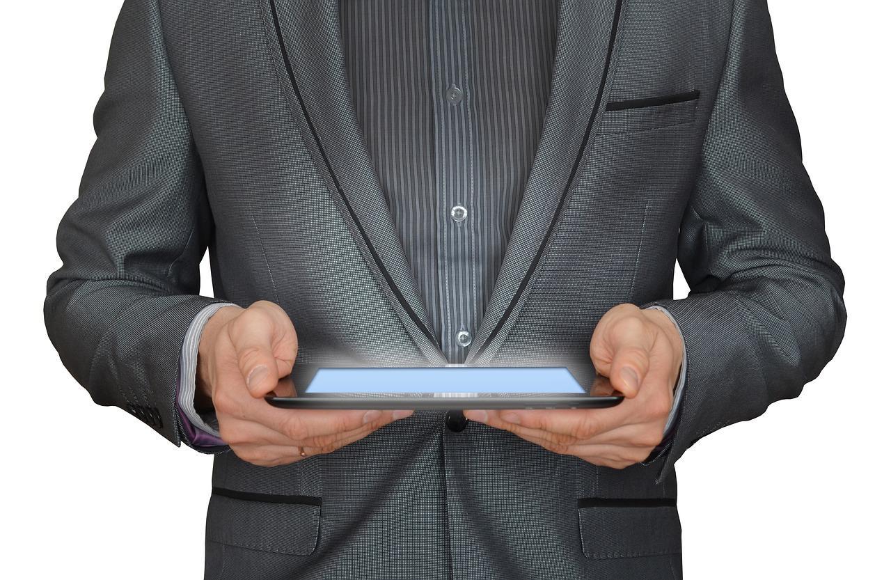 A businessman holding a tablet