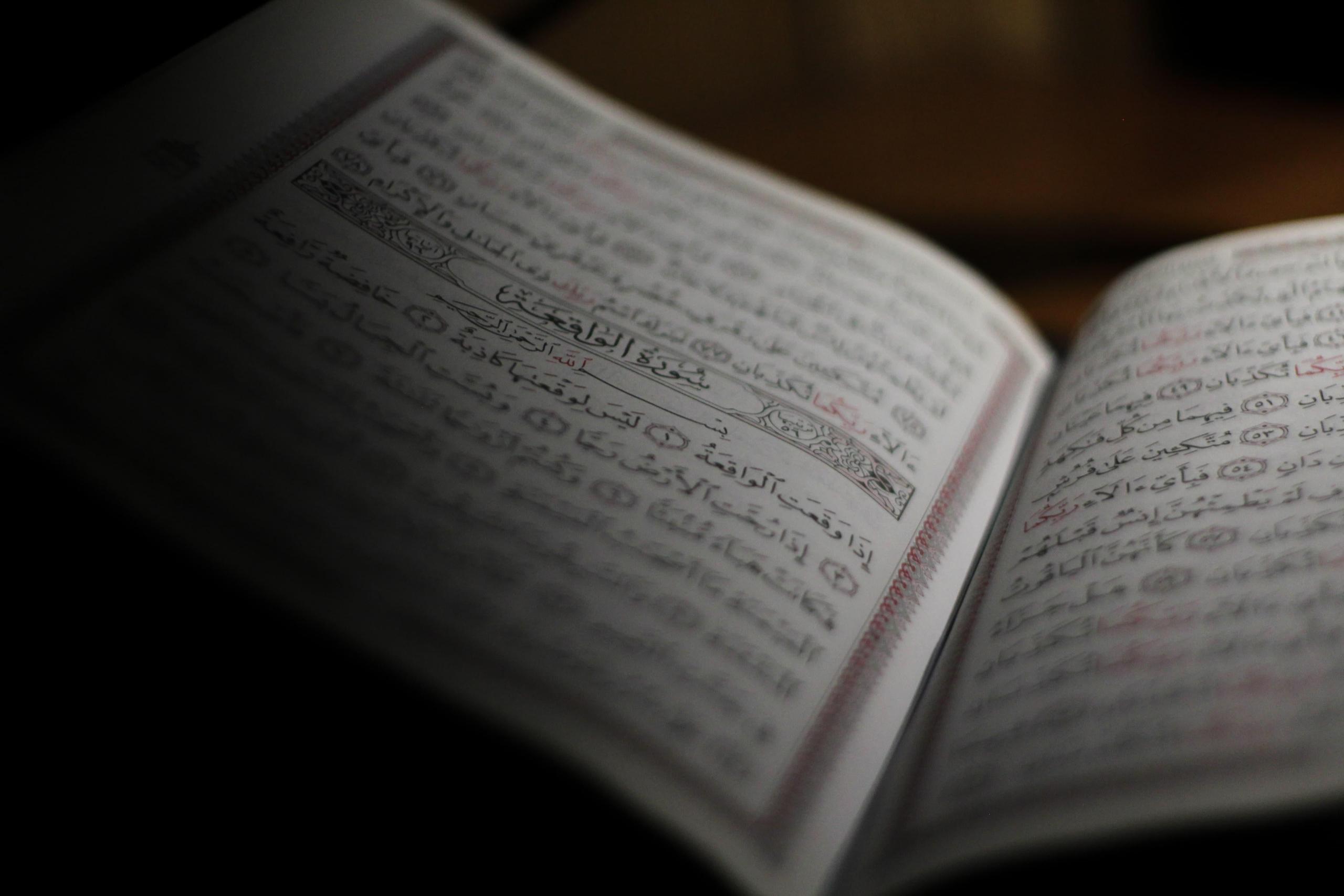 An Arabic book partially lit