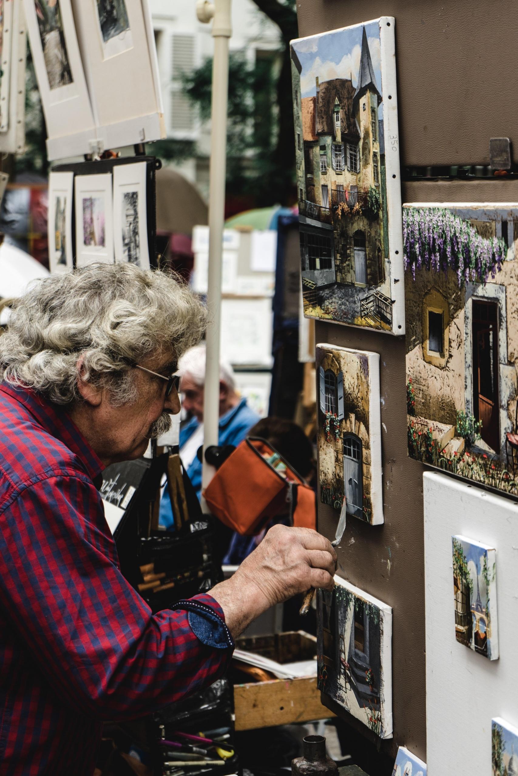 man looks at oil painting
