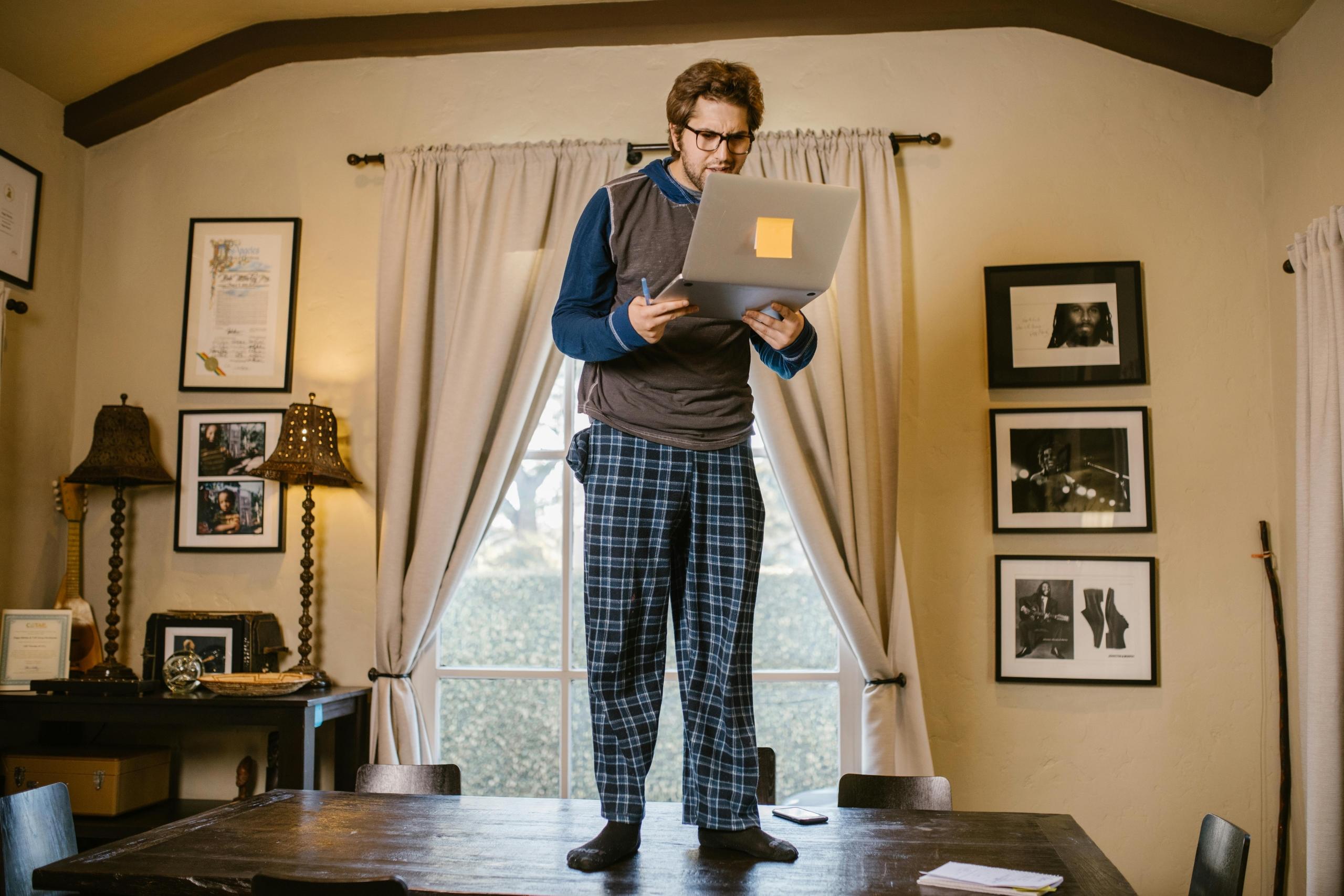 A student refreshing his laptop to check on the status of his university application