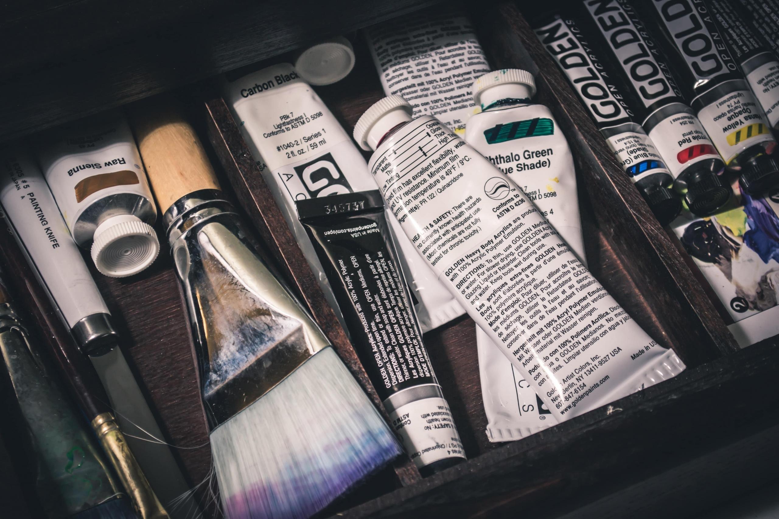 A collection of acrylic paint supplies.