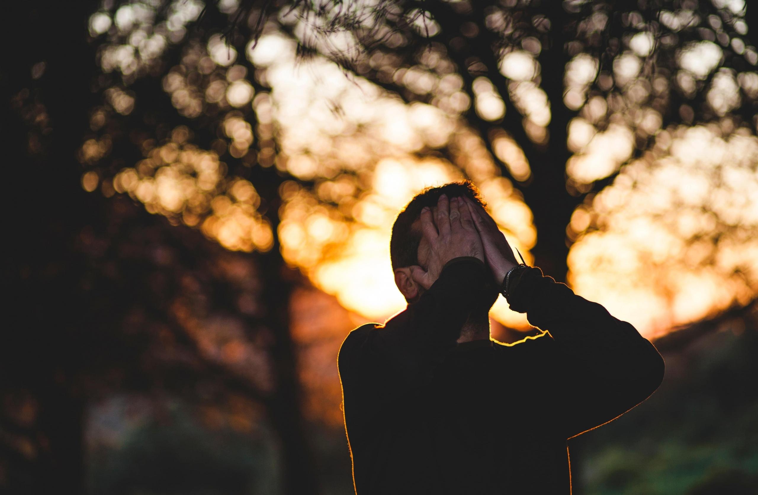 Man with head in his hands.