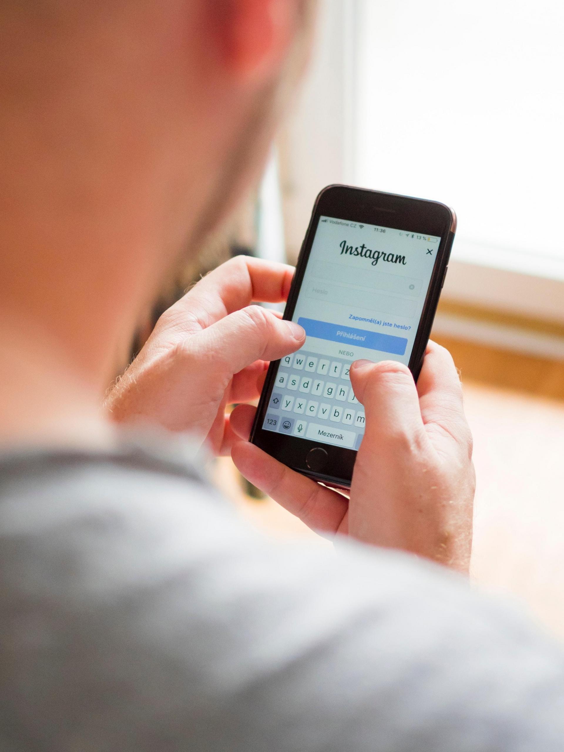 Man logging into Instagram account.