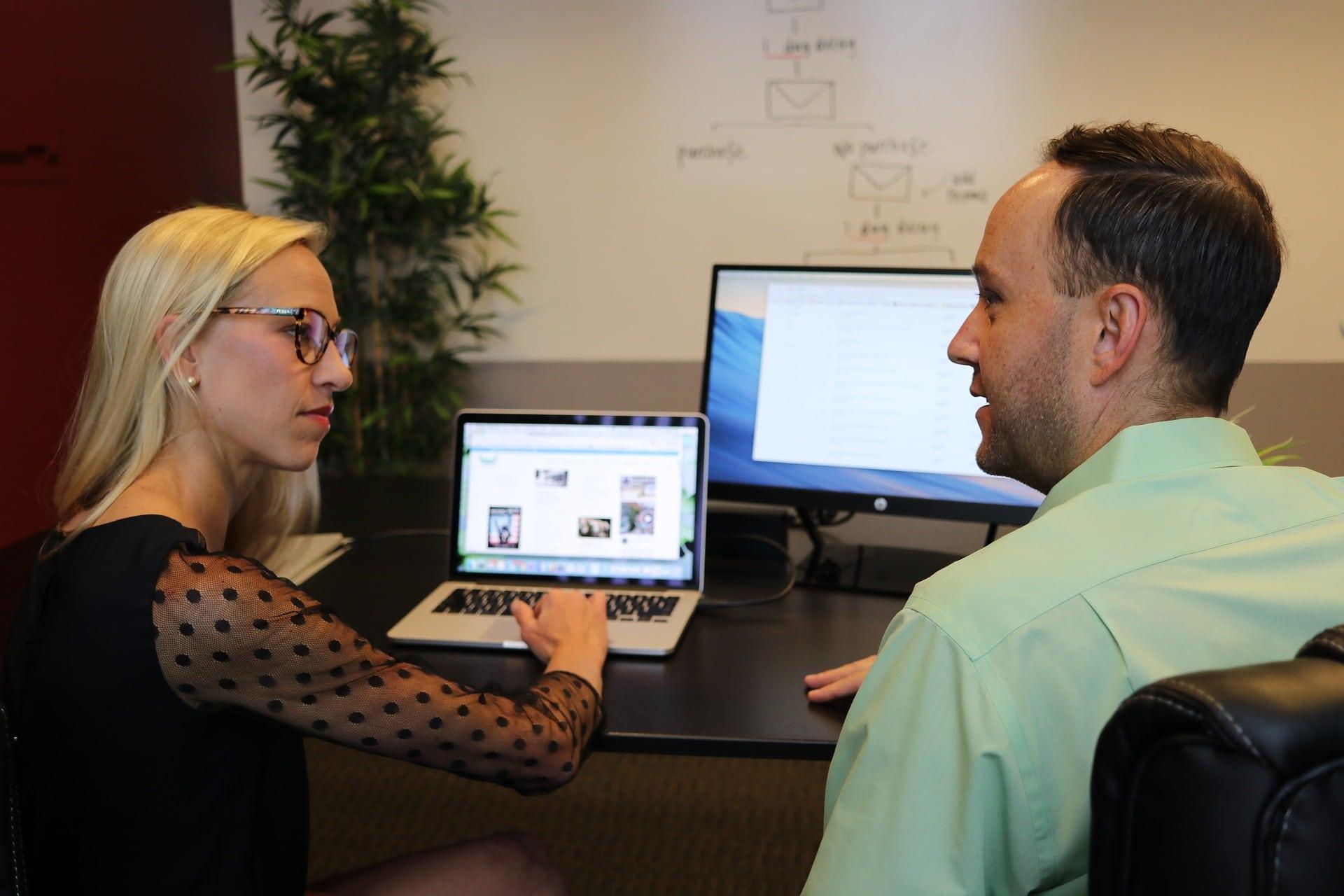two people working on a computer together