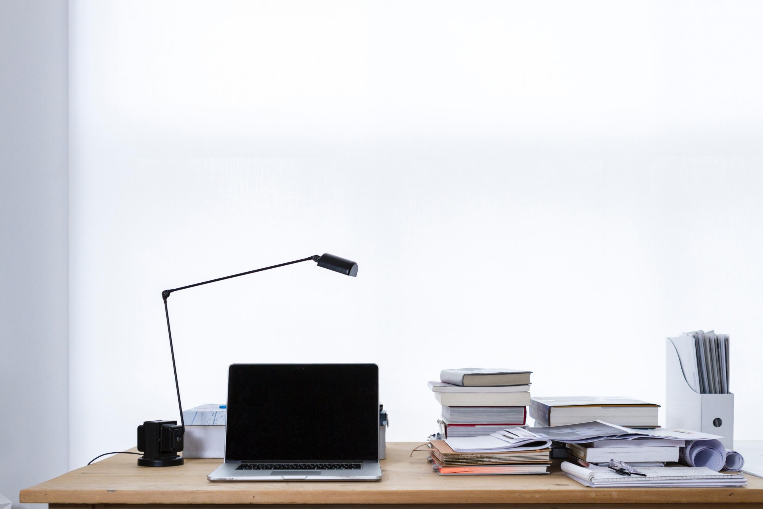 Laptop and paperwork on a desk