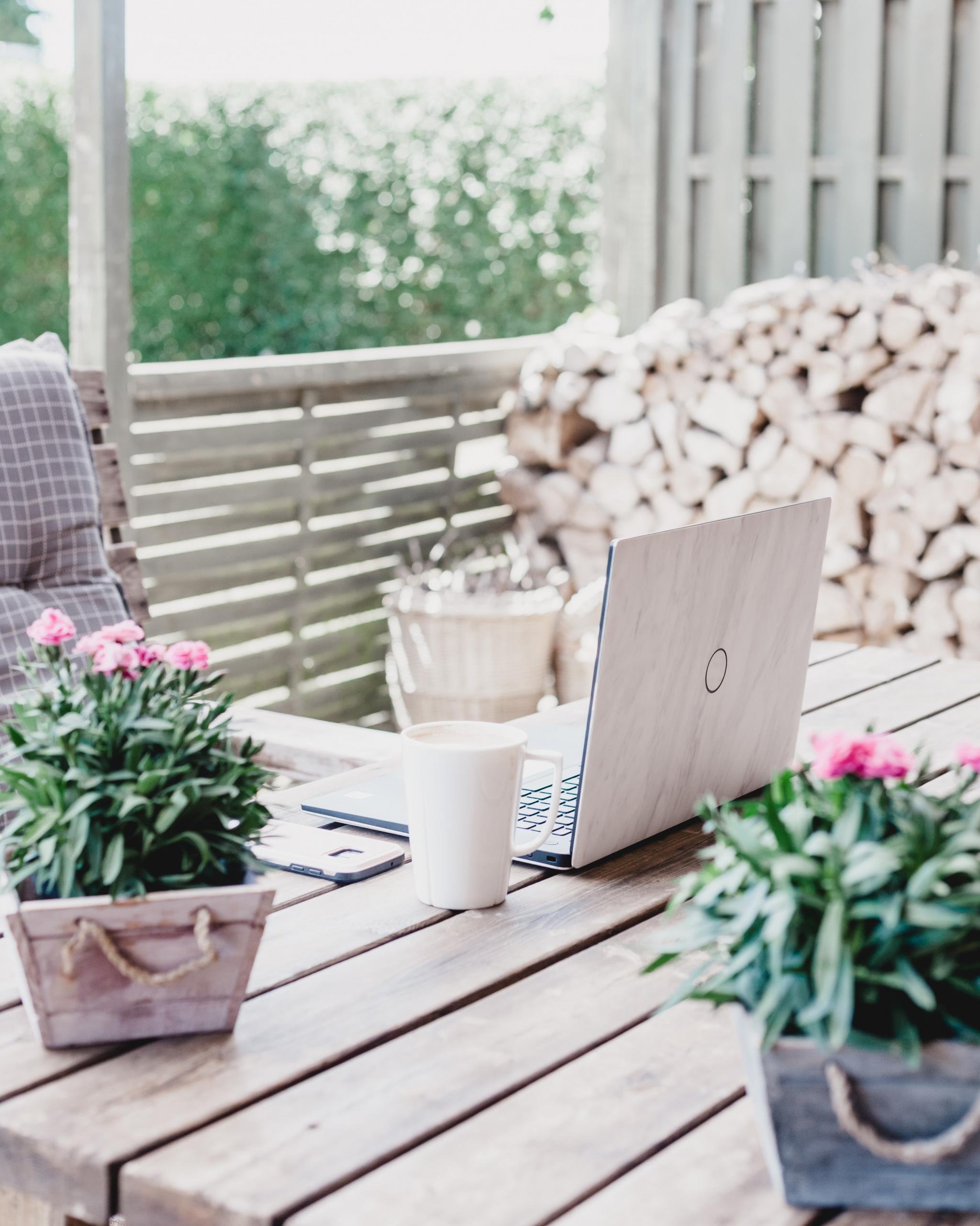 Outdoor desk with laptop and coffee