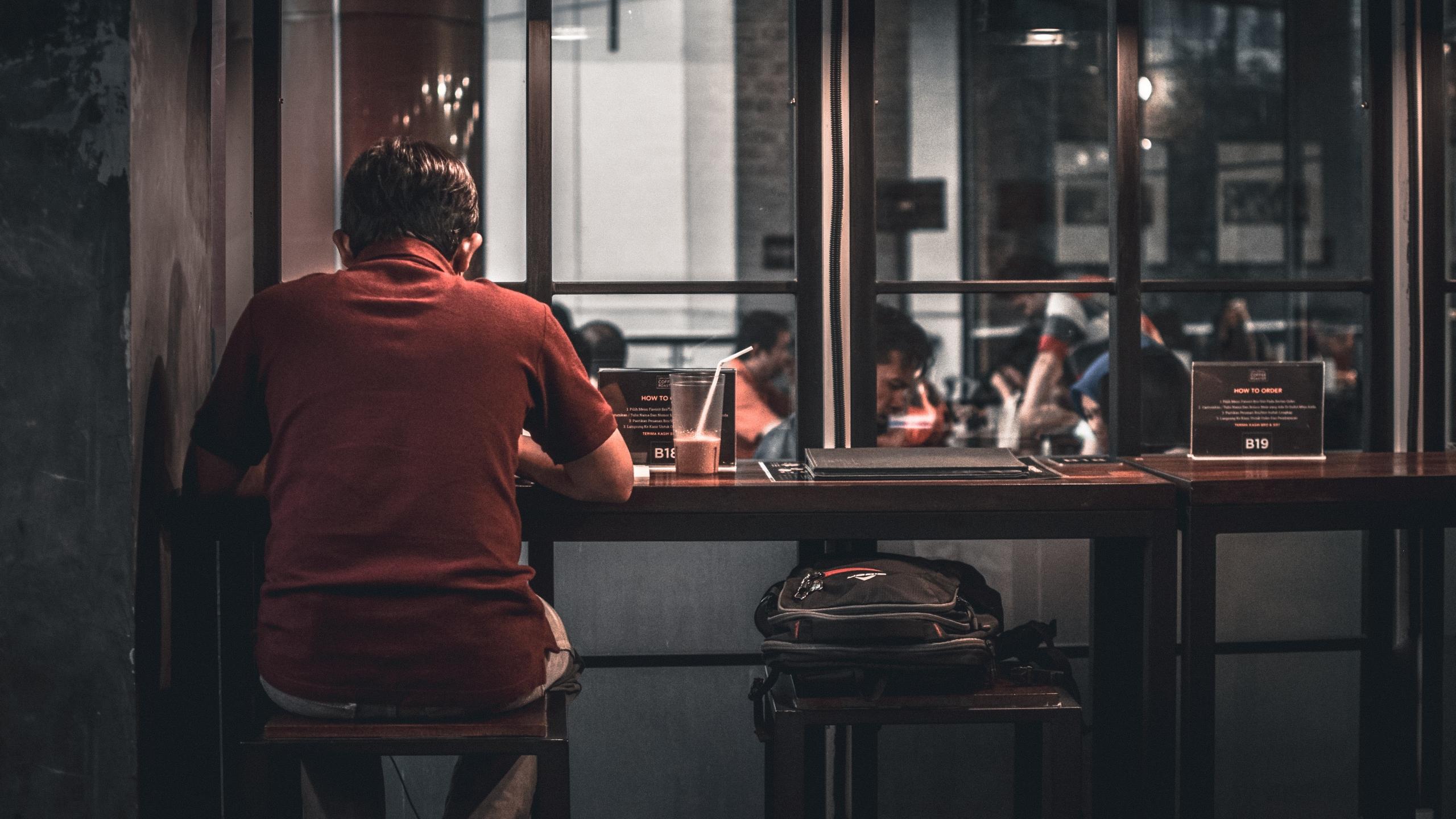 Man sitting on a stool working