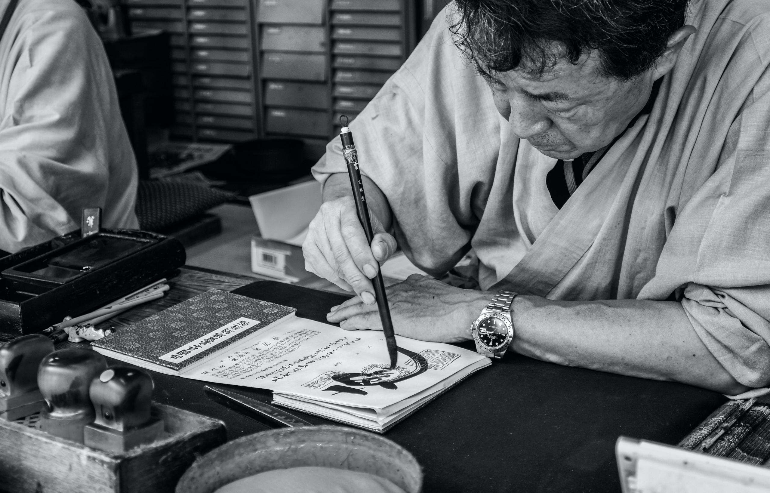 Man writing japanese