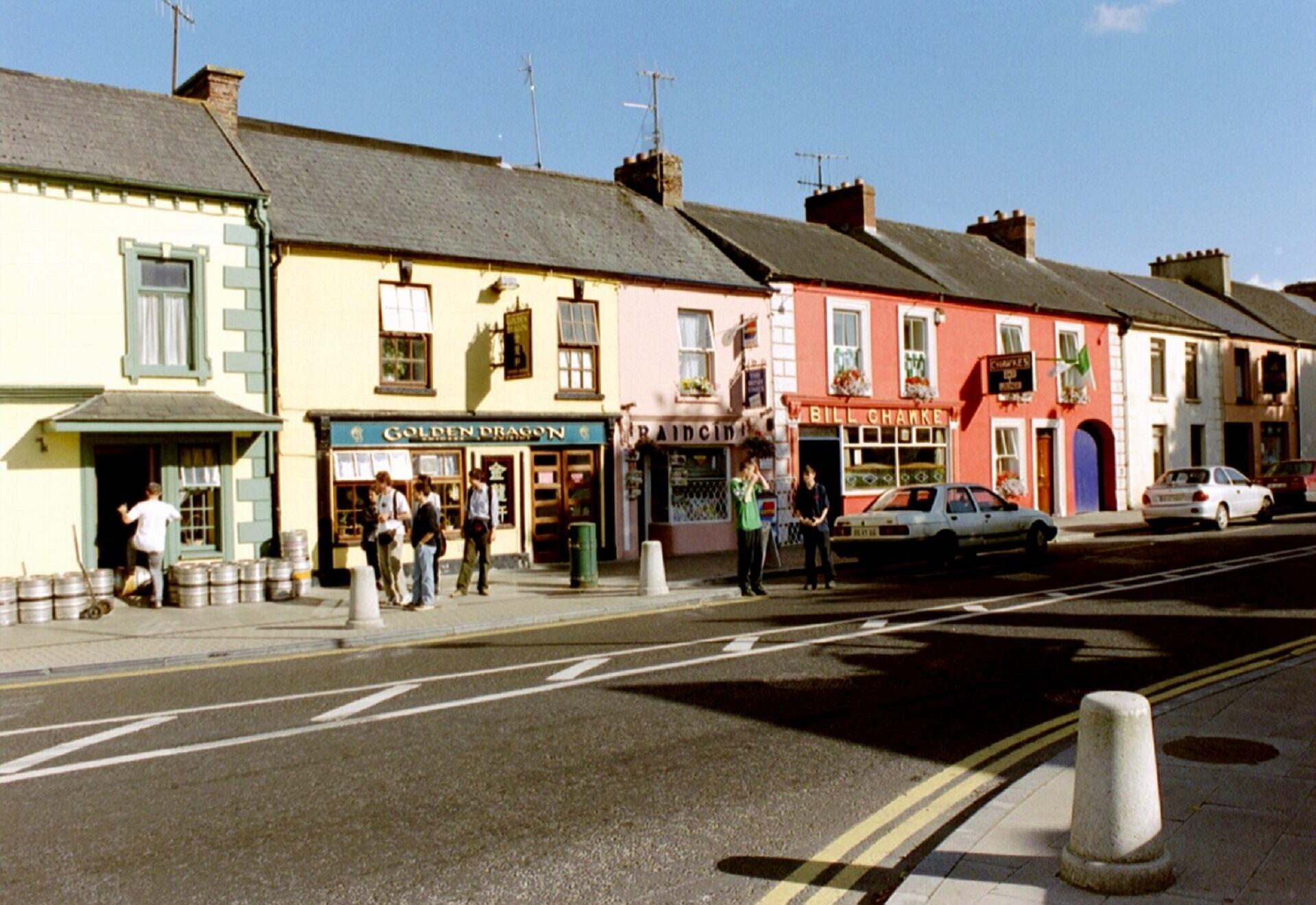 A row of colourful shops on a sunny day.