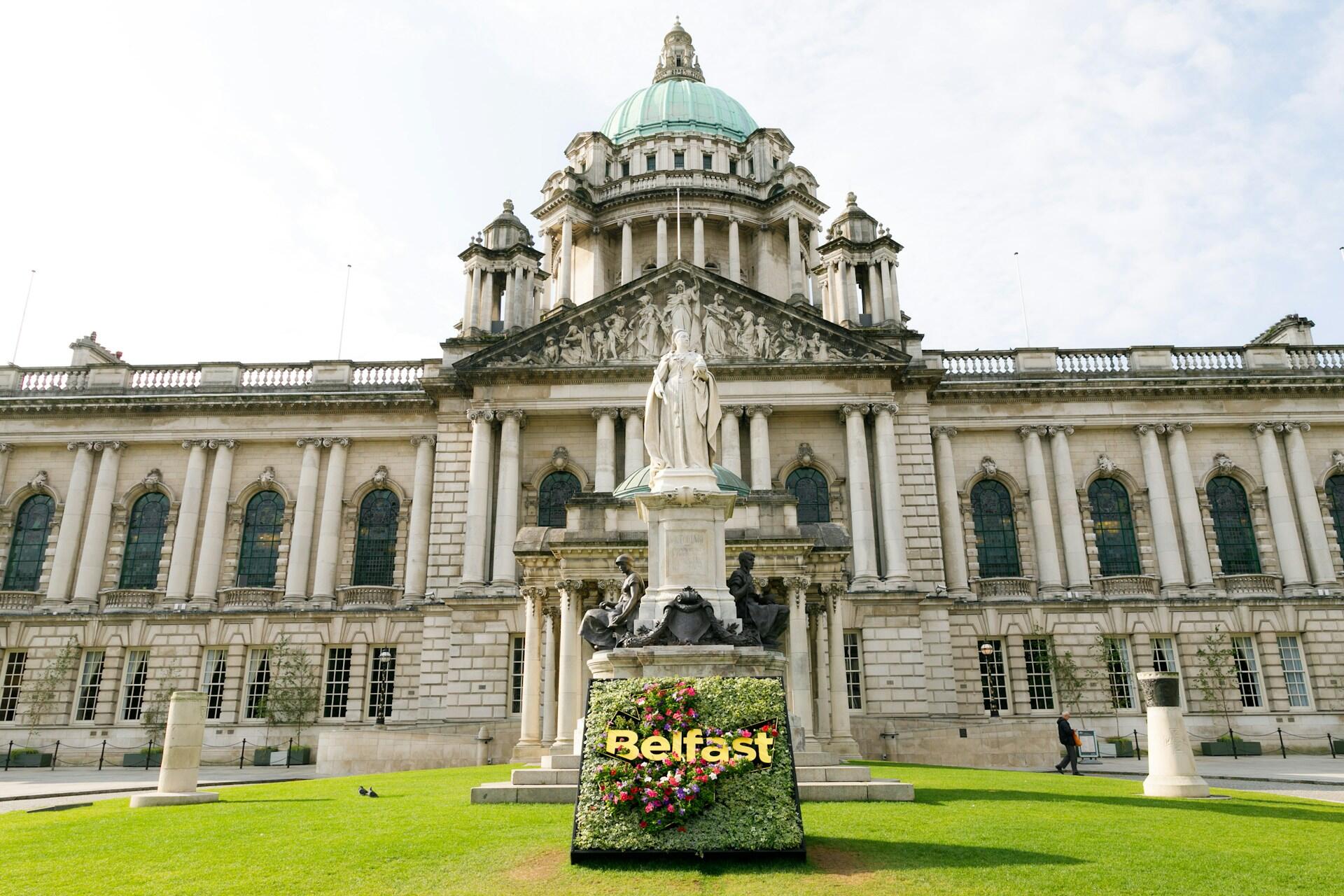 A large stone building with a green lawn in front of it.