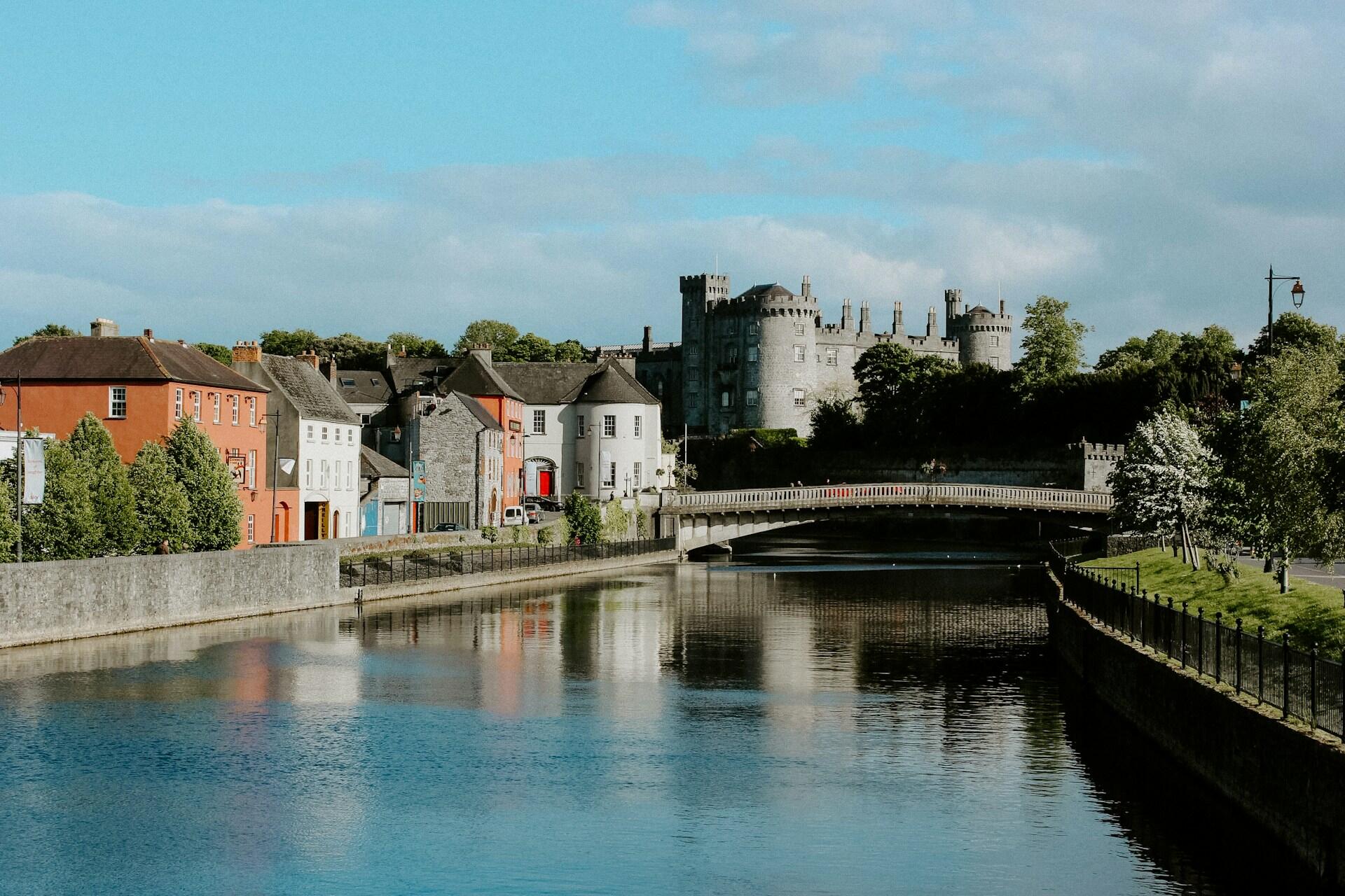 A body of water running through a town on a sunny day.
